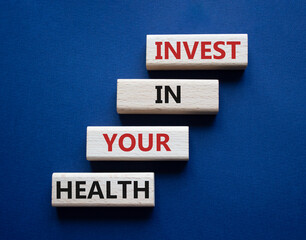Invest in your Health symbol. Concept words Invest in your Health on wooden blocks. Beautiful deep blue background. Business and Invest in your Health concept. Copy space.