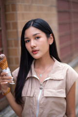 A young woman dressed in vintage clothing holds ice cream and looks cute at the camera.