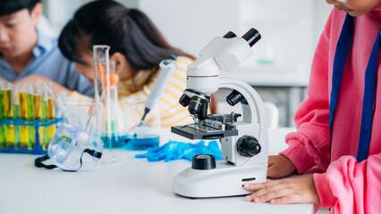 Close up of Primary class children engaged in hands-on scientific experiments. Students discovering the wonders of science through interactive and engaging experiments.