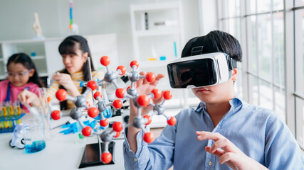 Child Explores Molecular Models with VR Glasses. Boy Wearing Reality Headset Interacts with 3D Molecule. Immersive STEM Education.