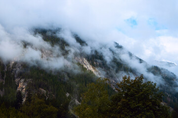Obraz na płótnie Canvas Mystic Mountains: Veiled in Fog, the Forested Peaks Evoke a Sense of Wonder