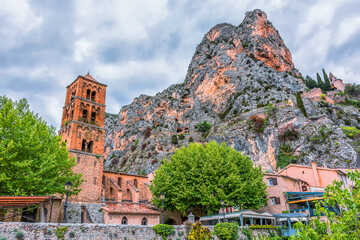 Scenic view of Moustiers-Sainte-Marie village in Provence, south of France against the french Alps...