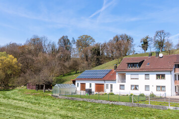 Fototapeta na wymiar Multi-storey residential building with garages and photovoltaic system in a rural area near Marxheim where the Lech flows into the Danube in Bavaria
