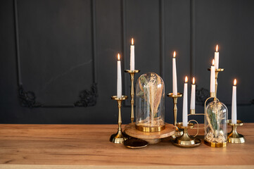 A decorated dining table or table in a restaurant. Installation of dried flowers and candles on a black background.