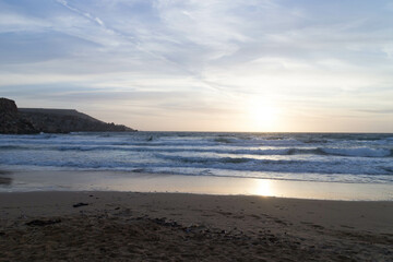 Stunning sunset over sea in Golden Bay Malta.