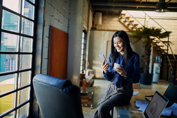 Young adult woman using smartphone during office break