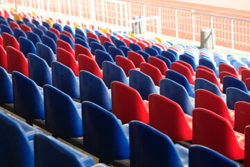 Naklejka premium Blue and red seats at stadium