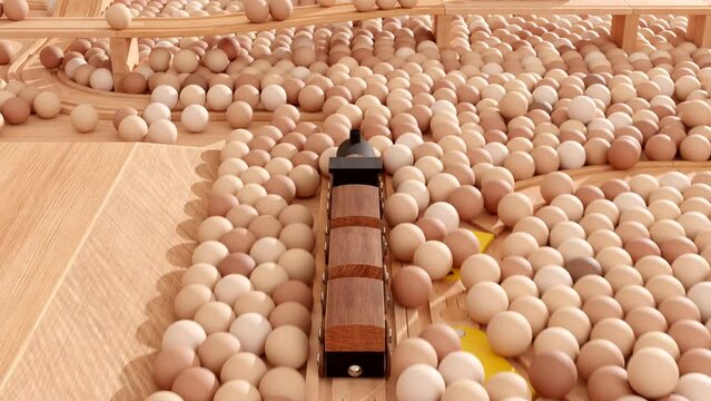 Closeup of a wooden toy train running on a rail set inside a ball pit.