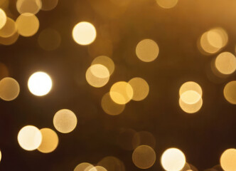 Golden abstract background with shiny golden floating bokeh.