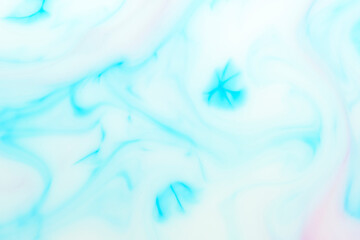 Fototapeta na wymiar Background with blue streaks on white milk. Marble texture.