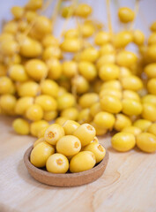 Close up and selective focus fresh dates fruits in wooden bowl.