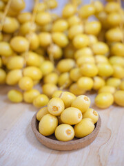 Close up and selective focus fresh dates fruits in wooden bowl.
