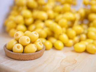 Close up and selective focus fresh dates fruits in wooden bowl.
