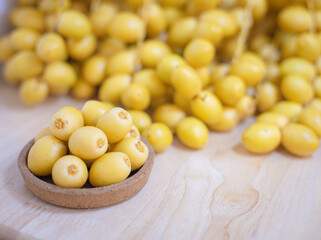 Close up and selective focus fresh dates fruits in wooden bowl.
