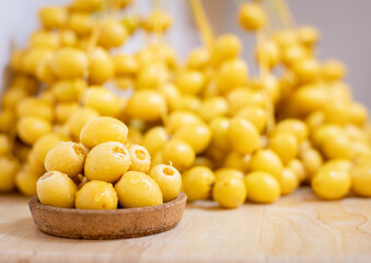 Close up and selective focus fresh dates fruits in wooden bowl.
