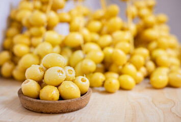 Close up and selective focus fresh dates fruits in wooden bowl.
