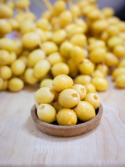 Close up and selective focus fresh dates fruits in wooden bowl.