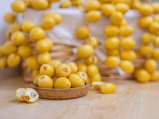 Close up and selective focus fresh dates fruits in wooden plate.	