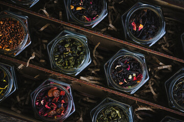 Set of various leaf tea packaged in jars. Black and green healthy tea with fruits, berries and herbs.