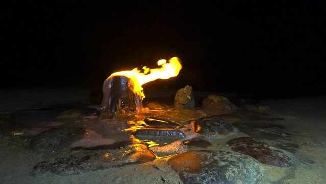 A burning spring in Kalmykia. A source of burning water in the village of Adyk, Russia. A source of fire water. Burning methane in the water. Cold fire. 4K Video