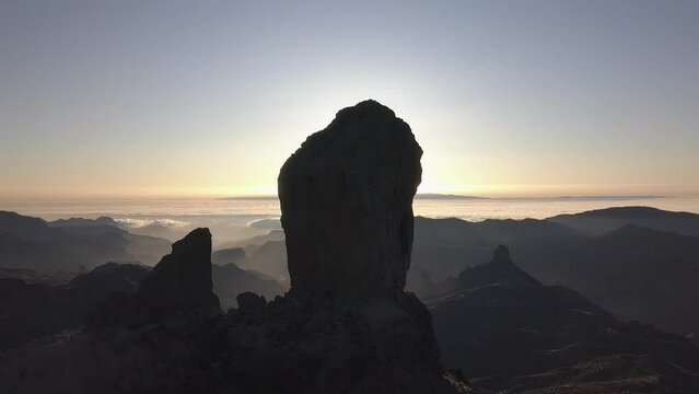 Aerial view of Roque Nublo and Mar de Nubes at sunset in the ravines of Gran Canaria (4K)