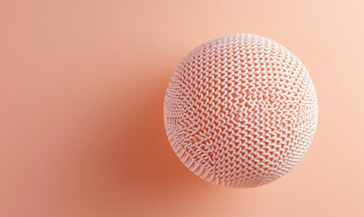 top view of  soft peach pastel knitted ball on a matching background color 