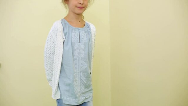Little girl stands on working vibrating platform in room