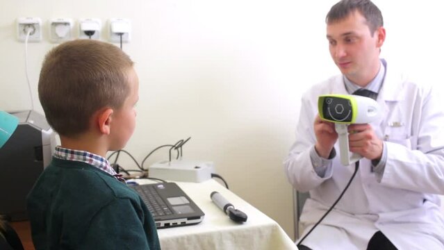Boy sits at mother lap during medical check in front of doctor