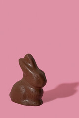 Chocolate rabbit symbol to Easter holidays isolated n a pink background.