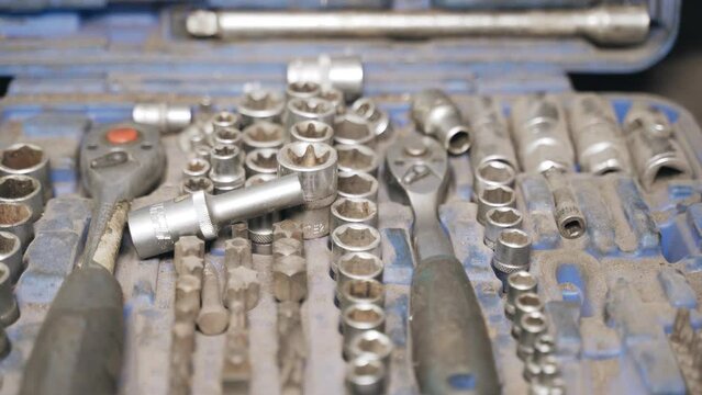Dusty auto mechanic tool kit. Background video of a set of keys.
