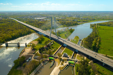 Vehicles drive on massive Redzinski Bridge in Poland on sunny spring day. Powerful cable-stayed...