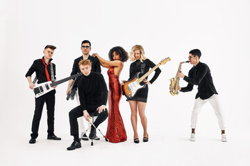Entertaining concept, teamwork. International group of musicians on a white background, guitarist, drummer, soloists, saxophonist. - obrazy, fototapety, plakaty