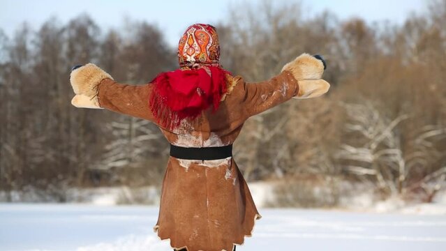 woman dances holding stretched garland of artificial snowballs