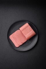 Delicious canned pink ham with salt, spices and herbs