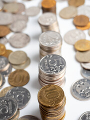 Close-up of a lot of Russian ruble coins on a white background. Columns of coins. The concept of the economy of growth, development. Budget, currency. Risks, banks