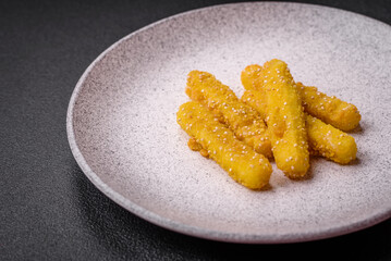 Delicious crispy cheese sticks with mozzarella, salt and spices, breaded and fried in oil