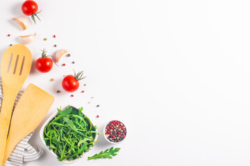 White cooking background with spices, vegetables and utensils. Top view. Free space for your text.