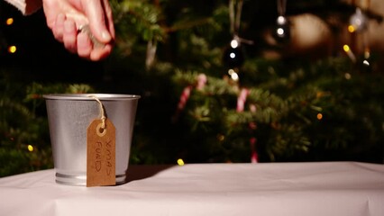 Saving money in tin for Christmas 