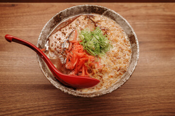 Top view roast pork chashu ramen noodle soup on wooden countertop. 