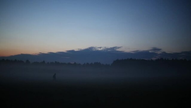Two people go on beautiful valley in fog at morning