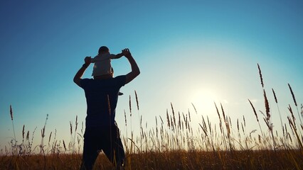 father and son in the park. father's day silhouette happy family child dream concept. father...