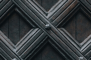 fragment of a decorative pattern in an old wooden door 