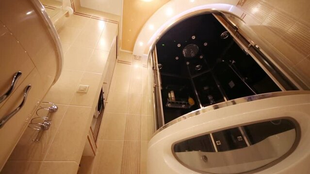 Under view of bathroom in Greek style with modern shower cabin