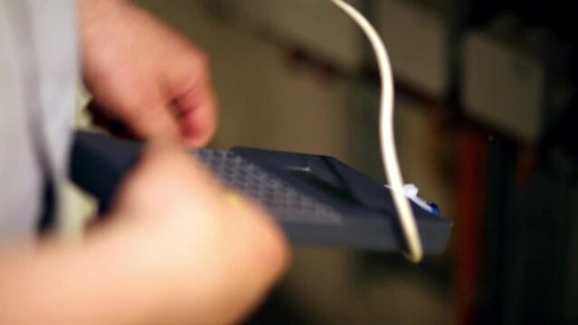 Tuning meter in hands of the worker, establishing intercom.