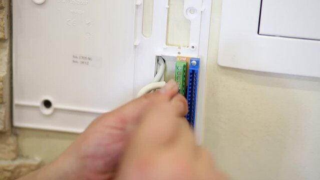 Male hands fix center conductor of coaxial cable 