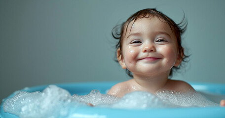 Baby infant taking bath, looking upwards and playing - obrazy, fototapety, plakaty
