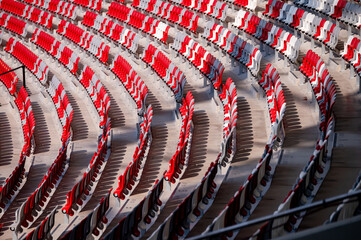 Empty red and grey seats at modern stadium