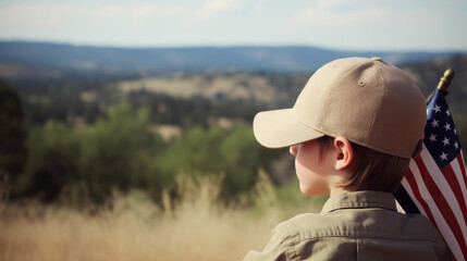 Fototapeta premium Child sitting near headstones with american flags