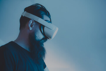 Man wearing headsets of virtual reality standing on  background looking away