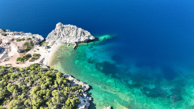 Aerial drone photo of not so famous but paradise  secluded sterna beach with crystal clear emerald sea near iconic lake Vouliagmenis, Loutraki, Greece